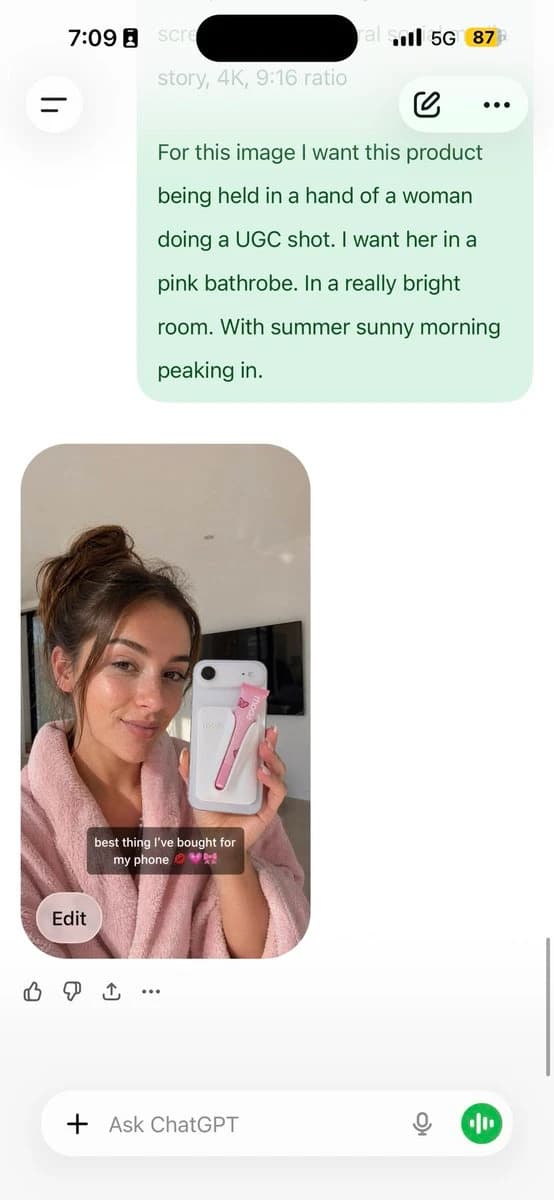 A woman in a pink bathrobe holds a phone with a pink accessory in a bright room, illuminated by morning sunlight