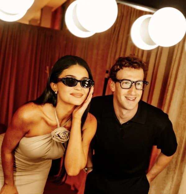 Candid party photo with privacy face blocks, flash-lit group framing, and casual nightlife atmosphere