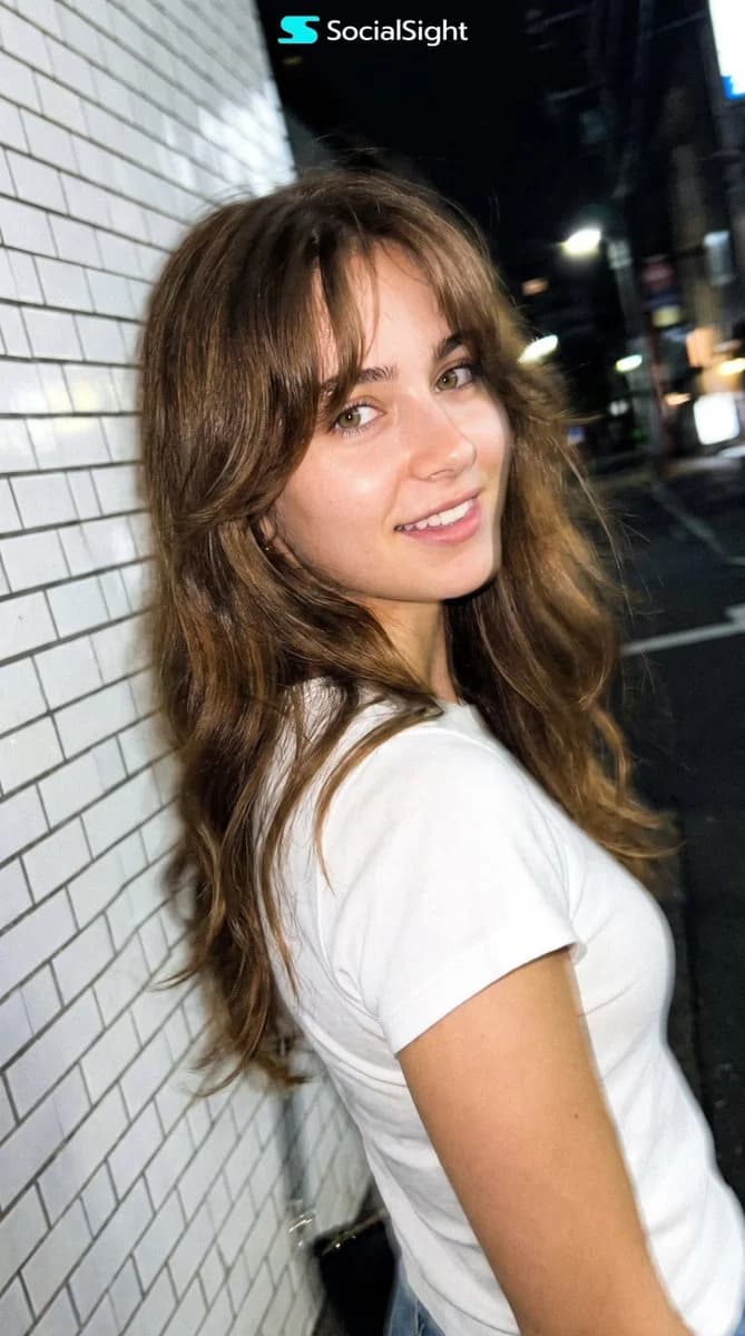 A candid Tokyo night smartphone portrait inspired by street beauty photography, with neon ambience and natural low-light texture