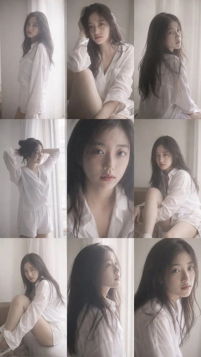 A young Korean female idol poses in a white shirt, captured in a grainy, candid style with harsh flash and soft, dim lighting
