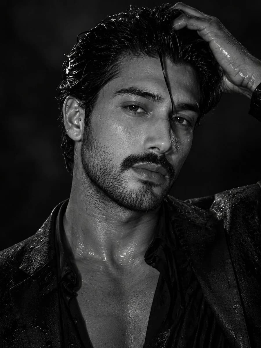 Cinematic monochrome male portrait with sharp facial detail, deep shadows, and sophisticated fashion lighting