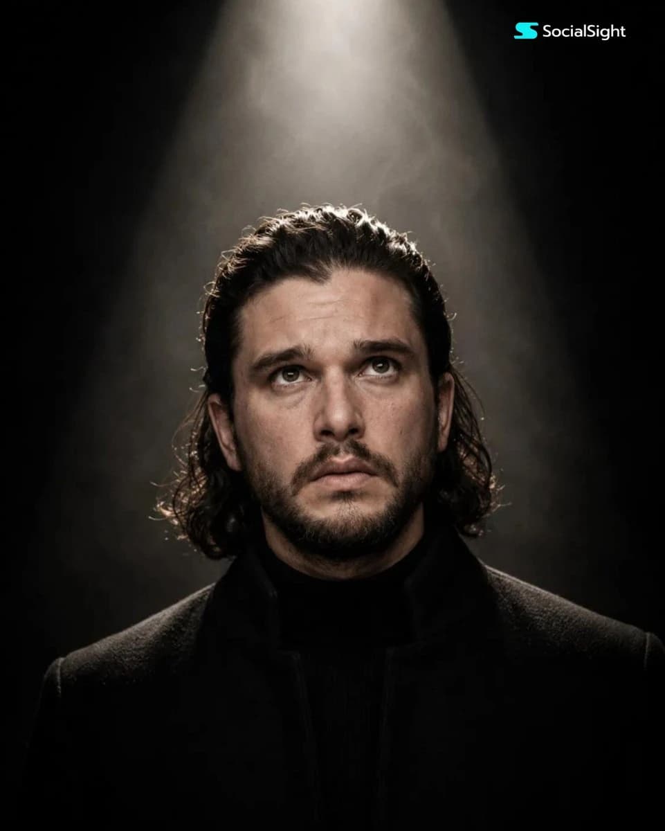 Cinematic spotlight studio portrait centered under a single overhead light against a dark dramatic background.