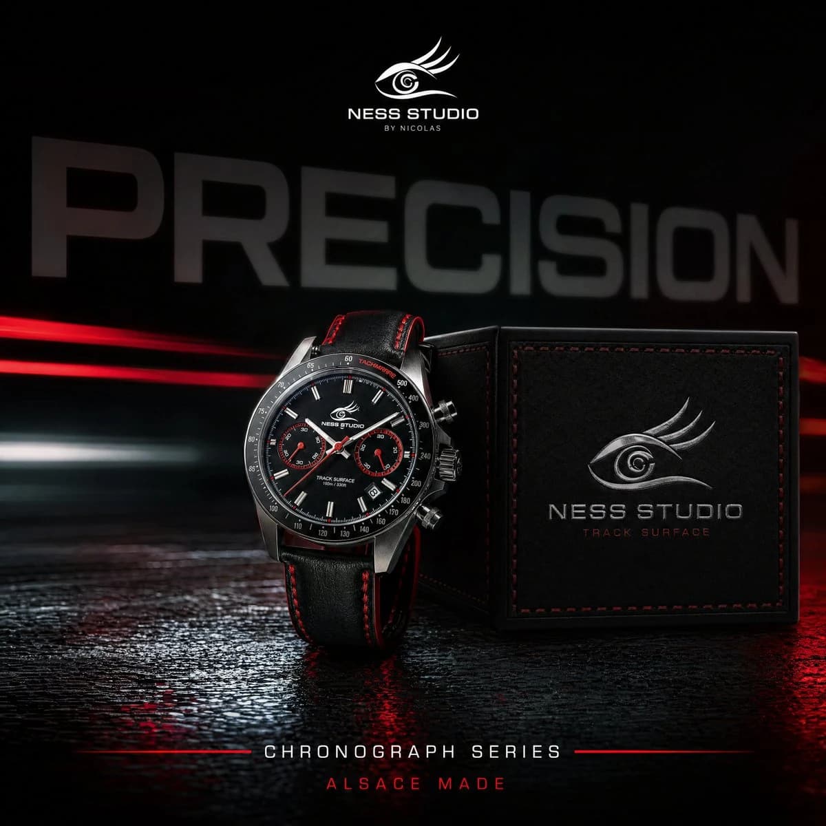 A stainless steel chronograph watch with a black dial and red accents stands beside a textured black box, highlighted against a blurred "PRECISION" backdrop